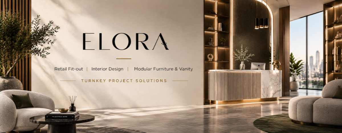 Promotional banner for ELORA, a turnkey project solutions firm specializing in retail fit-outs, interior design, and modular furniture. The image showcases a luxurious modern lobby with a marble reception desk, warm wood paneling, built-in shelving, and comfortable lounge chairs in a bright, contemporary office space.