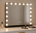 A rectangular vanity mirror with a black frame and glowing round light bulbs around the border, placed on a white dresser with cosmetics nearby.